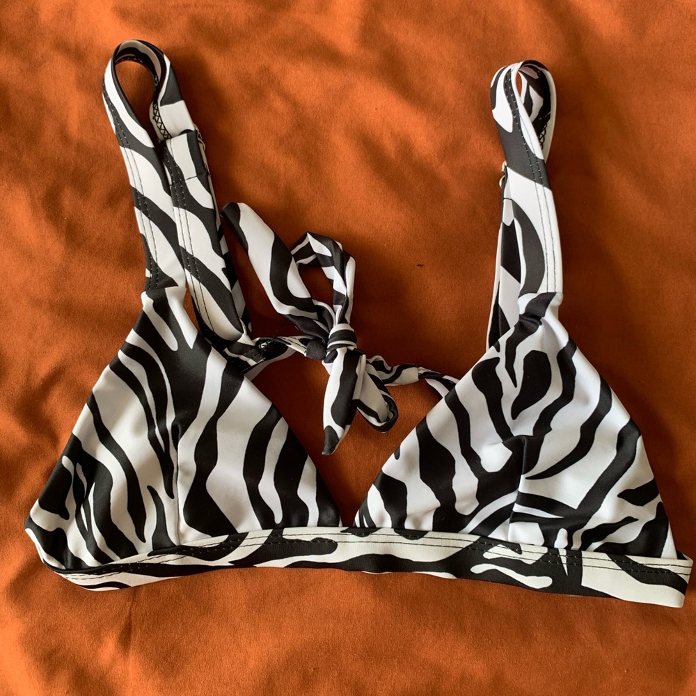 Women’s bikini top, black and white zebra print, new, size extra small.
